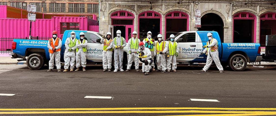 HydroForce Restoration and Cleaning crew in front of a commercial building